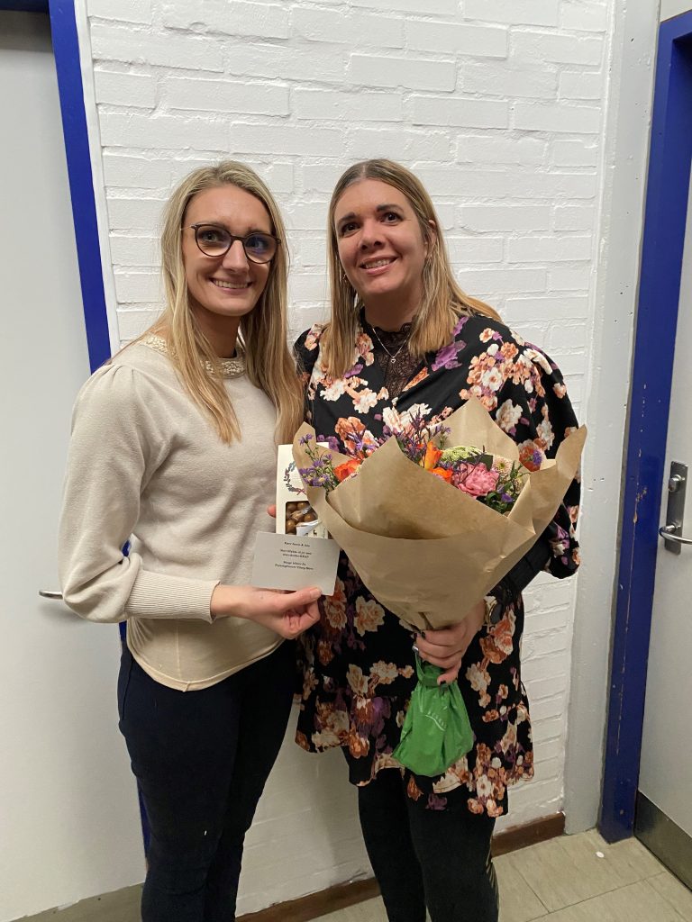 2 kvinder står med blomster Skulder KRAP